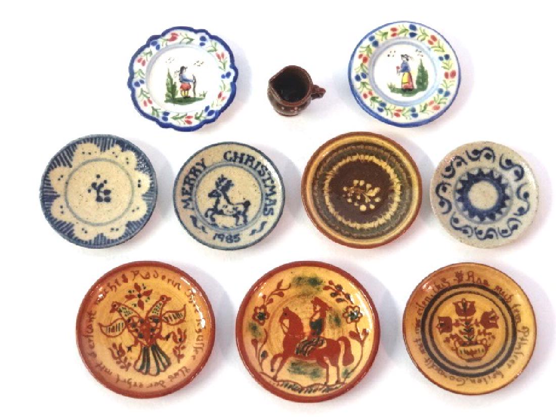 Jane Graber Dollhouse Redware, China & Stoneware: Jane Graber dollhouse four Pennsylvania German style slip decorated redware plates and a mug 3/8"H, two faience style plates 7/8", three stoneware blue decorated plates