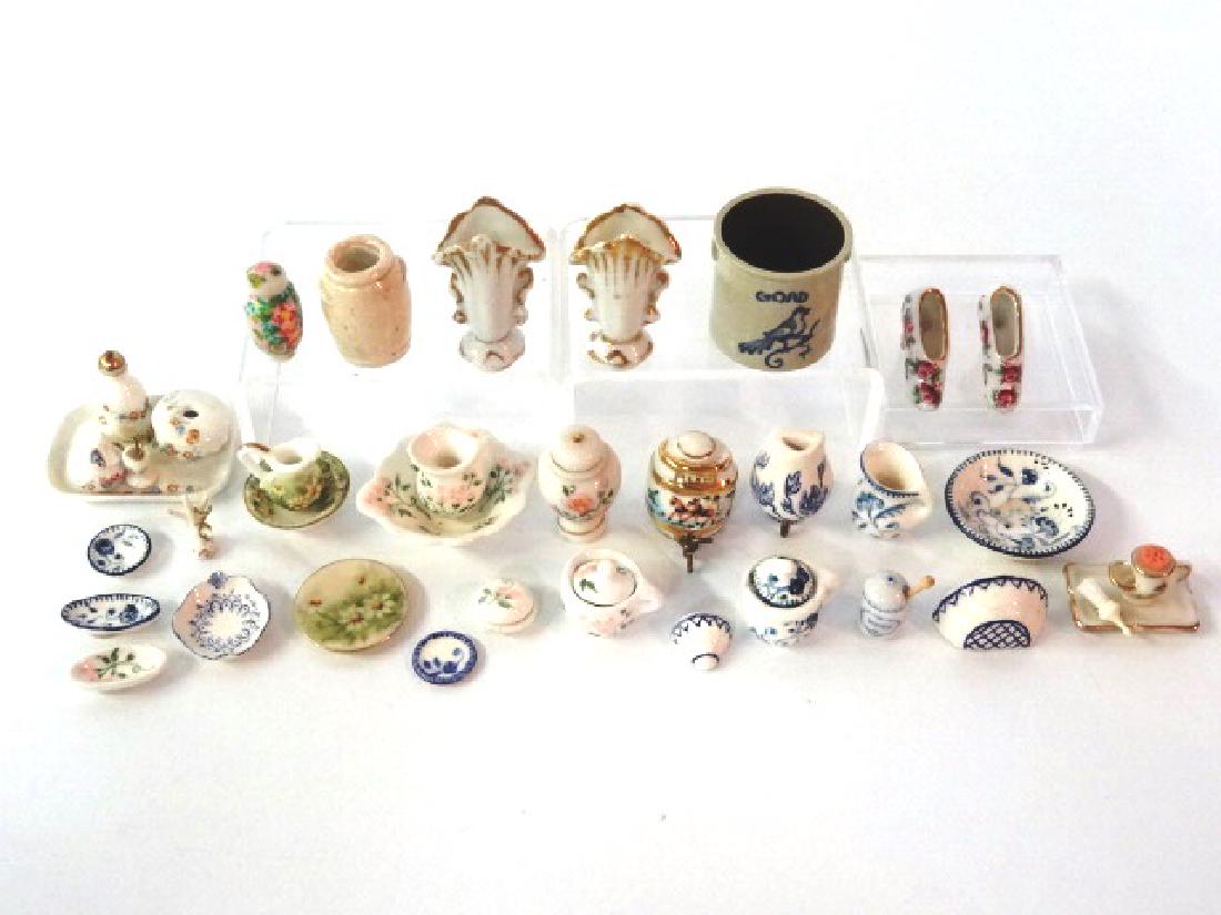 Selection of Dollhouse China Miniatures: Grouping of small dollhouse china, a few with maker's marks, Goad stoneware crock with cobalt bird decoration 1 1/8"H, vases, crock, plates, pitcher & bowl, shoes, dresser set, bowls etc.