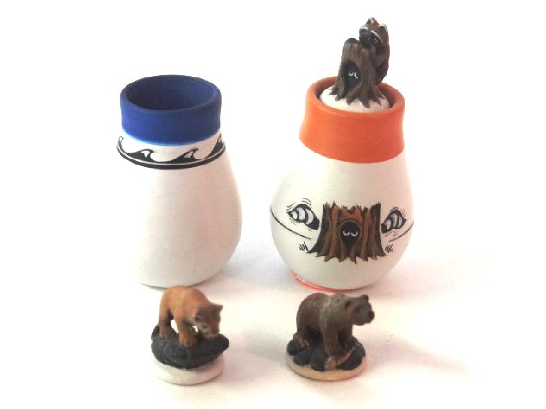 Teresa Wildflower Artisan Dollhouse Pottery & Figurines: Teresa Wildflower unique piece of miniature dollhouse pottery, body has hand painted tree trunk with eyes peeking out flanked by two raccoon tails, stopper is a figural tree trunk with eyes peeking ou