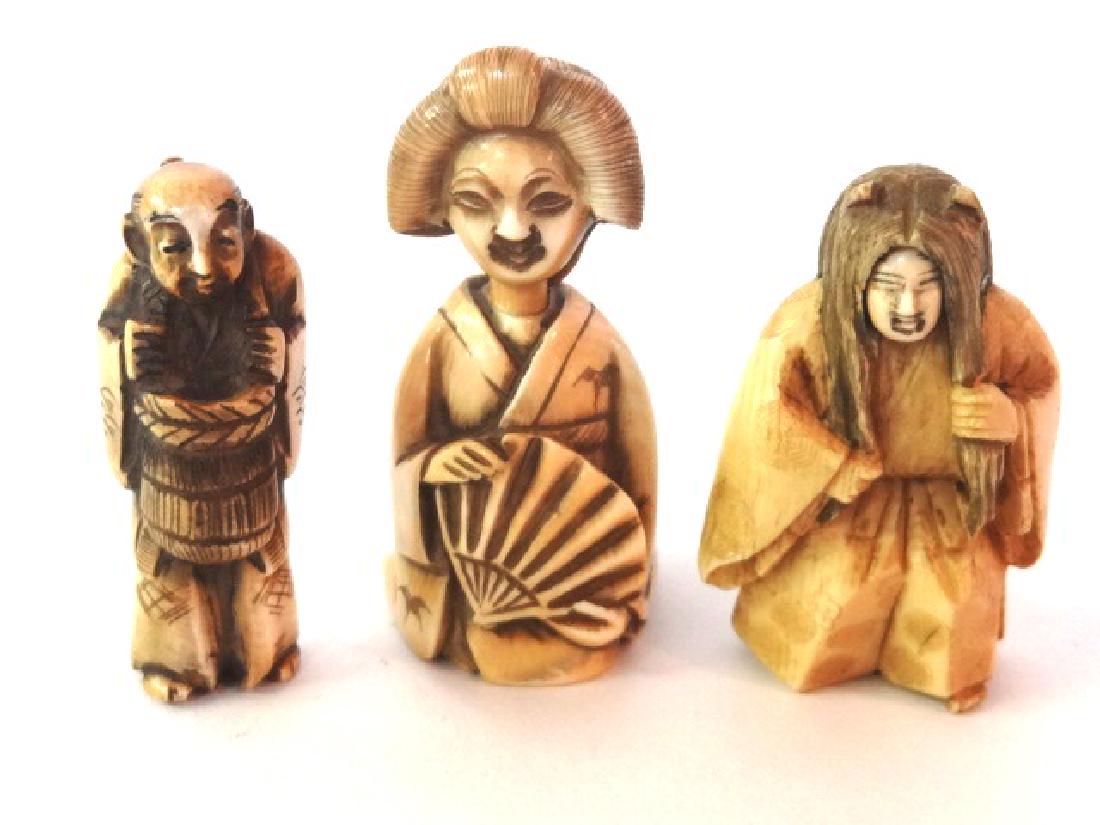 Three Vintage Carved Netsuke Miniatures: Carved netsuke with double spinning face 2 1/8"H, signed workman netsuke carrying basket 2"H, signed lady netsuke with fan may also be a snuff bottle 2.5"H