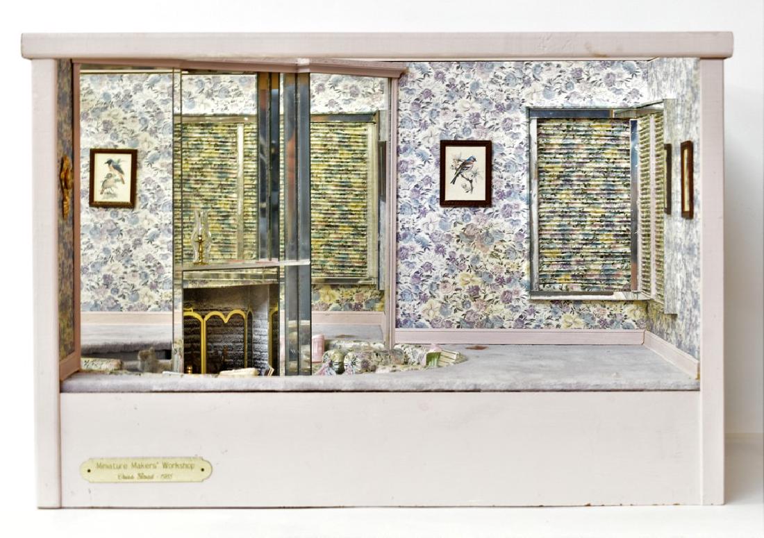 Goad Dollhouse Living Room Box: Criss Goad hand made sunken living room doll box, demilune sunken seating area with two custom sofas, china table, mirrored fireplace wall with lighting, removable glass top and front, 18.5"W, 12.5"H,