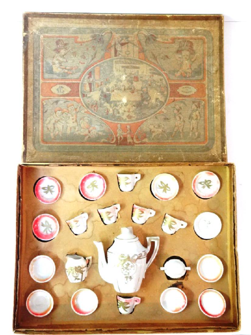Antique German Boxed Doll Tea Set Miniature: Early antique German boxed china tea set by MC, fitted box 10.5" by 14" with charming graphics contains teapot 4"H, creamer, sugar, six cups & saucers and six plates