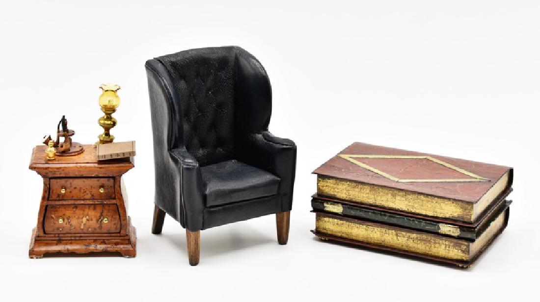 Whitledge & Reverie Dollhouse Furniture Miniatures: Ray Whitledge hand painted coffee table styled as a stack of books 3.5"W, 2.25"D, 1.5"H, Reverie Miniatures leather wing chair with tufted back 3.75"H, artisan Bombay style two drawer chest made of hi