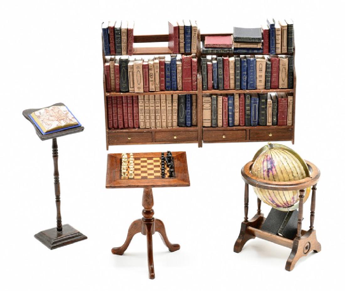 Artisan Dollhouse Library Furniture & Accessories: Gary Larsen two attached mahogany bookcases with drawers in base filled with faux books 5"W, 3"H, Carl Isabelle mahogany book stand with faux map book 3.5"H, unsigned mahogany game table with inlaid c
