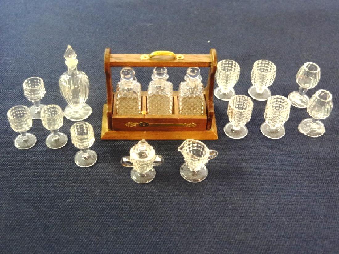Ferenc Albert Dollhouse Glass Barware Miniatures: Ferenc Albert glassware, mahogany tantalus 1.5"W signed FK or FH filled with three Albert glass decanters, also loose decanter, creamer, sugar bowl and ten wine glasses in various styles