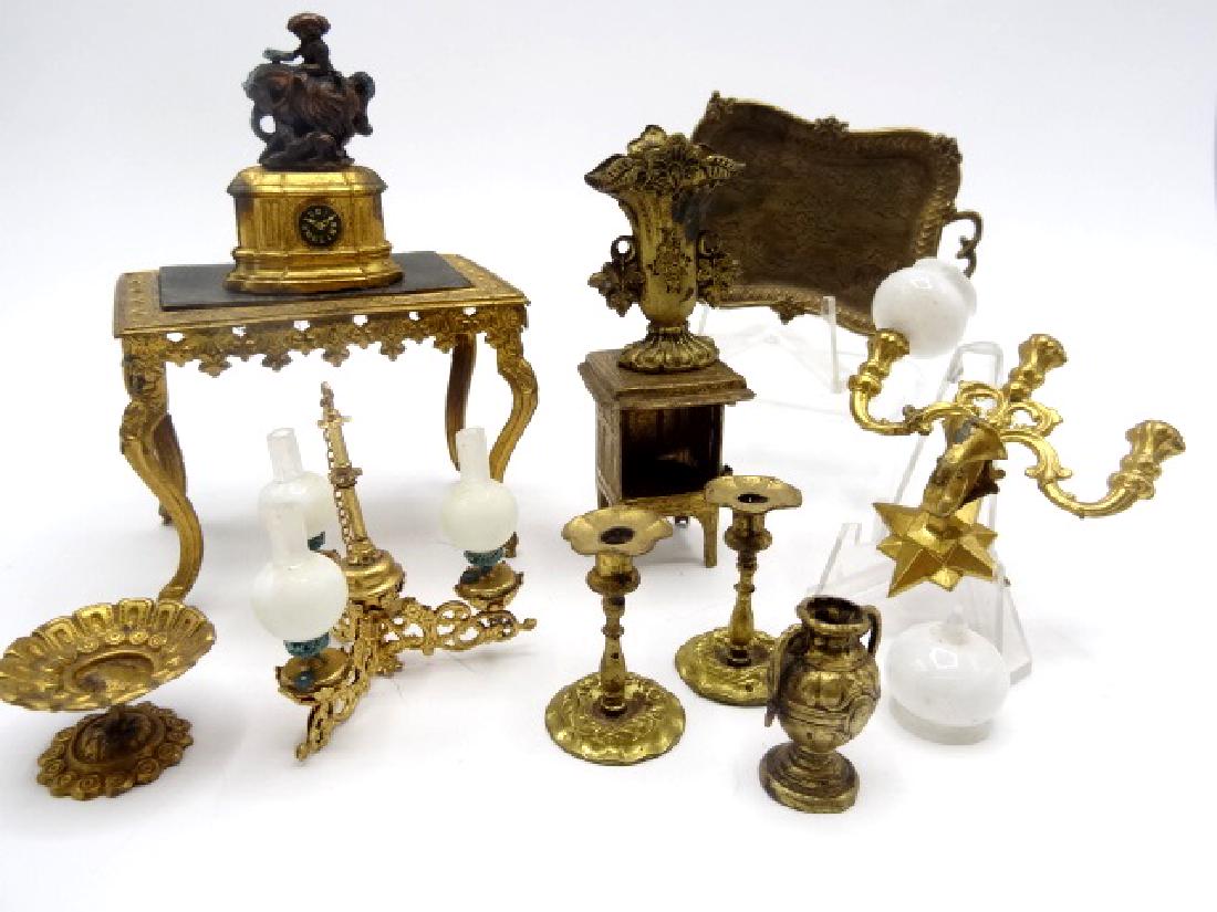 Antique Dollhouse Ormolu Furniture & Accessories: Antique dollhouse ormolu table with ornate skirt and cabriole legs 3 1/8"L, 2 3/8"H, 2"D, double handle serving tray 3 1/8"W, three socket sconce 2.75"W missing a globe, mantel clock with hunter on ho