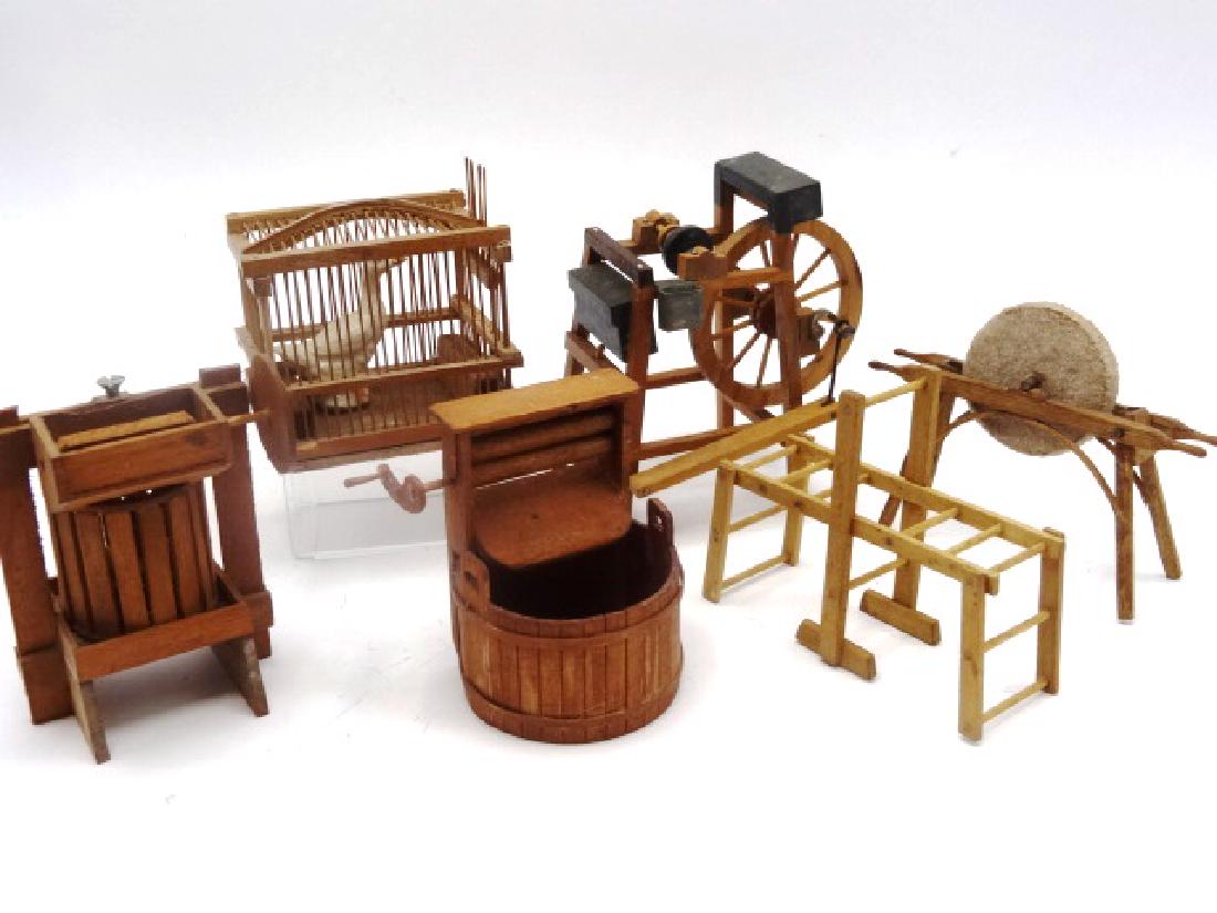Dollhouse Miniature Farm Accessories: Wooden cage with ceramic goose 3"W, monkey bars 3.5"W, vintage hand crank sharpening wheel 4"L, vintage foot powered pulley system 4"H, Jim Gans fruit press 3.5"H, Jim Gans laundry bucket with wringer