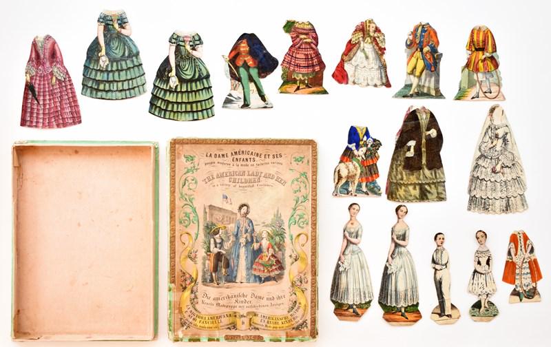 The American Lady And Her Children Paper Dolls: Mid-19th century boxed paper doll set The American Lady And Her Children, two piece hand colored box printed in English, French, German and Italian has taped flap corners, includes 4 dolls front and b