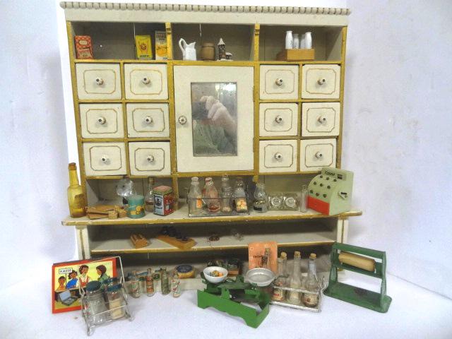 Vintage Toy Store Display & Accessories: Vintage wood toy store display with older repaint, 12 pullout drawers and a mirrored door over 2 shelves 21"W, 20"H, 5.5"D, includes miniature glass lantern candy containers, bottles and canisters, ti