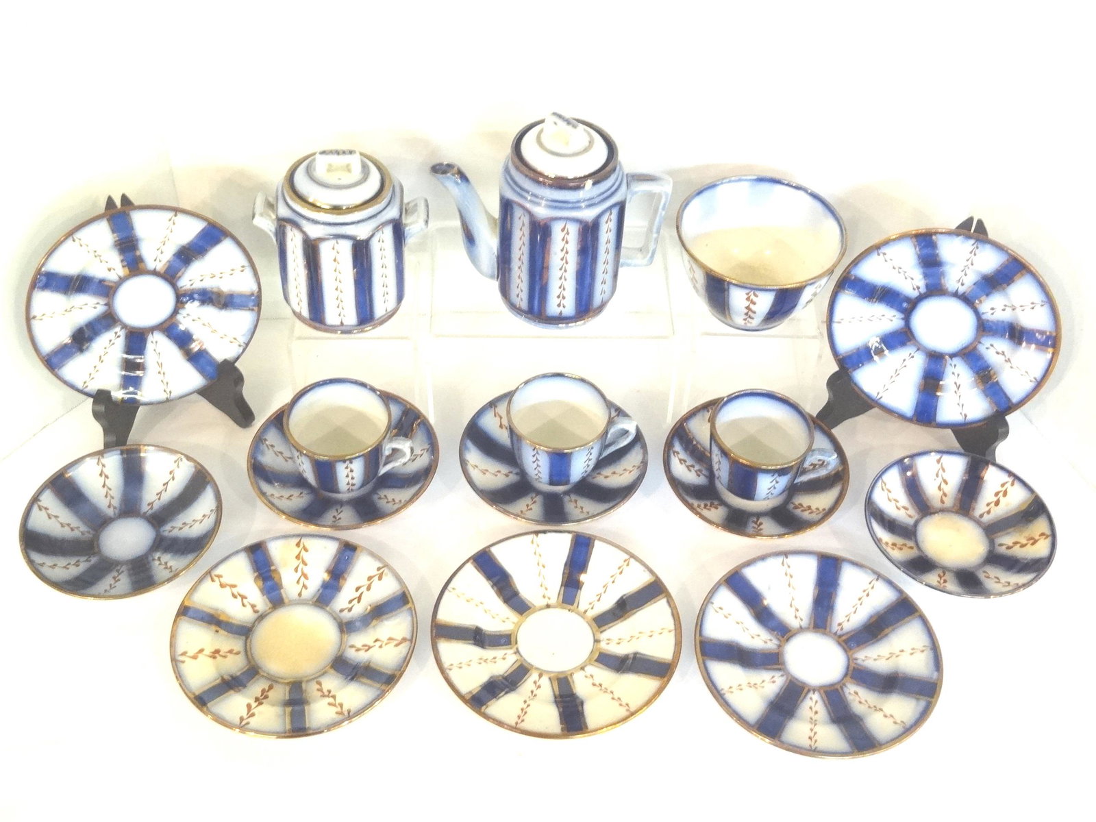 Allerton Wagon Wheel Child's China: Antique Allerton child's tea wares in the wagon wheel pattern, tea pot 5"H with rim chip, covered sugar bowl, deep bowl 4"D, 5 plates 5.5"D, 3 tea cups and 5 saucers 4.5"D