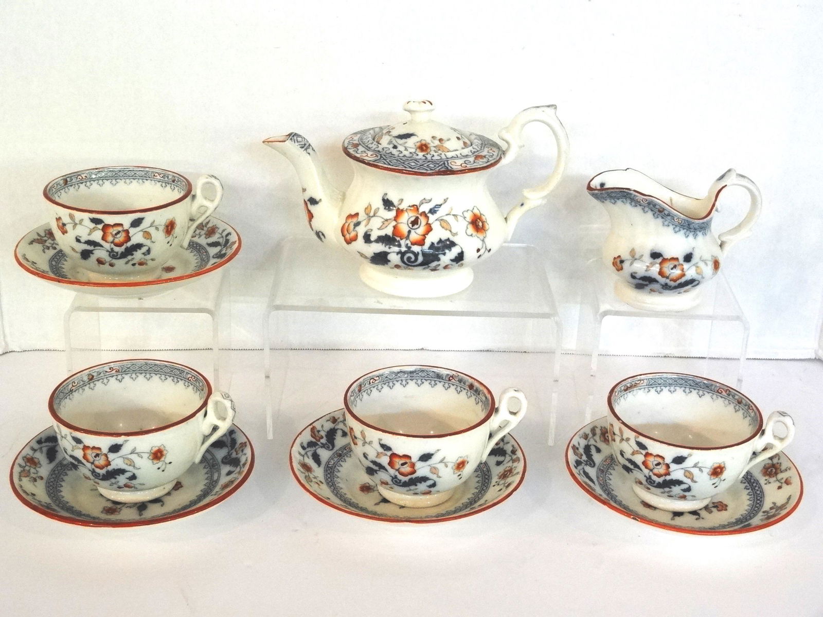 Antique Child's Tea Wares: Antique floral decorated child's china, teapot 6.5"L, creamer with rim chip, 4 tea cups with a few small rim frits, 4 saucers 4.5"D