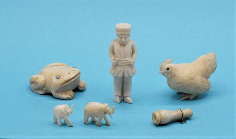 Group Of Small Miniature Carvings: Nice grouping of small dollhouse sized carvings, frog with turquoise eyes 1.25"L, rooster missing a toe 1.5"L, Dutch boy with chipped foot 1 7/8"H, two small elephants, antique small bone Stanhope mon