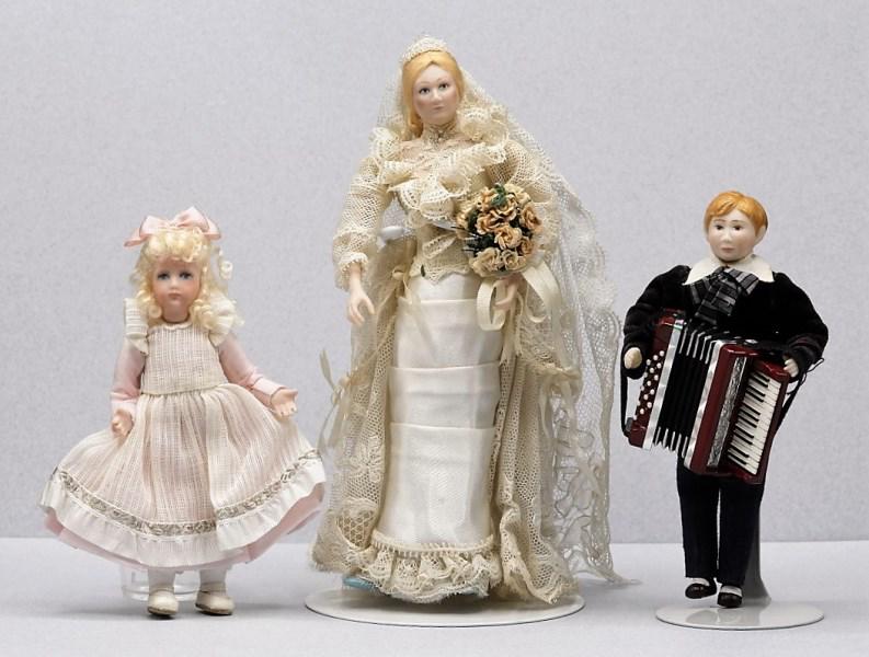 Three Liz Staryk Dollhouse Dolls Miniatures: Three Liz Staryk bisque dolls, bride with bouquet and veil 5.75"H, boy playing an artisan Robert Street accordion 4.25"H, young girl 4"H