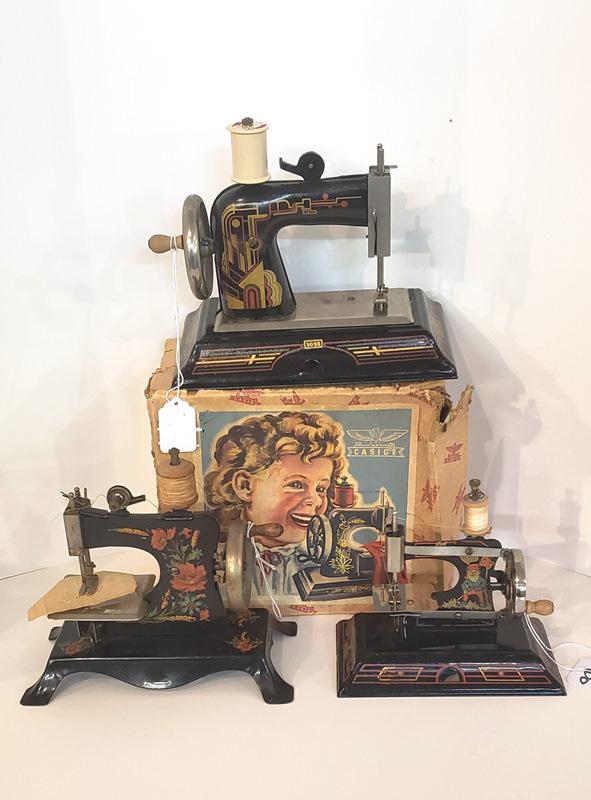 Three German Childrens Sewing Machines: Three German childrens sewing machines - 2 Casige and 1 unmarked, 1 Casige in OB, largest machine 6 1/2" x 9"