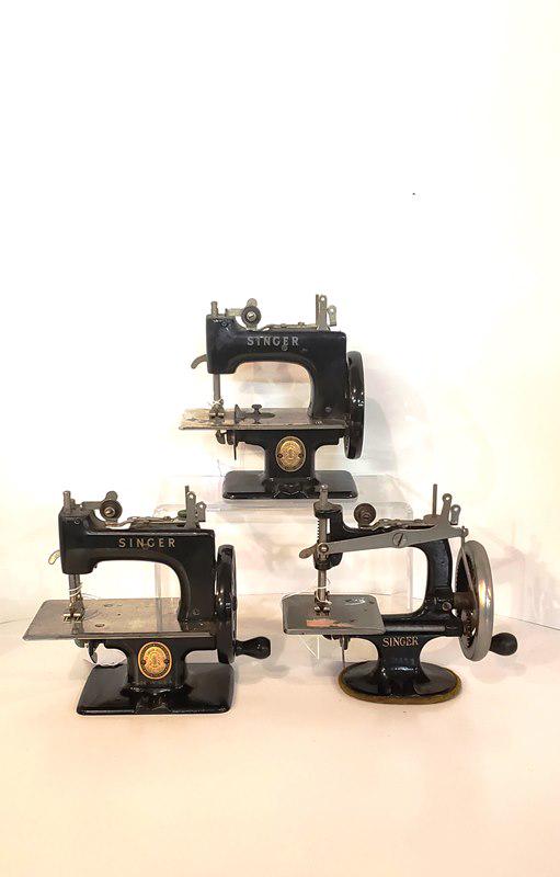 Three Childrens Singer Sewing Machines: Three childrens Singer sewing machines, 1 made in Great Britain, 2 made in USA, 1 cast iron, largest 7" tall