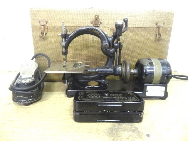 Wilcox & Gibbs Sewing Machine: Wilcox & Gibbs Sewing Machine Cast Iron in original case , electric motor, Has original attachment box, not tested 21" L , 7' D , 1211/4 "
