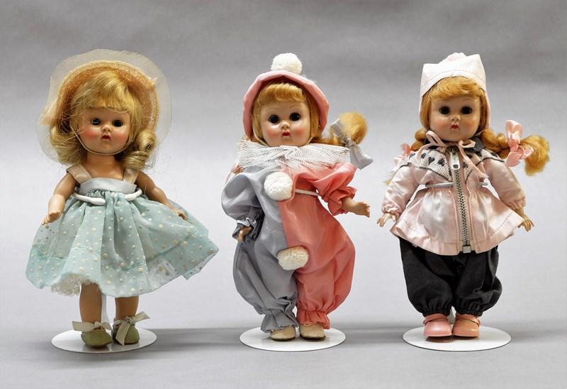 Three Vogue Ginny Dolls: Three 7" hard plastic straight leg walker dolls, two in original tagged clothes, clown suit is not tagged