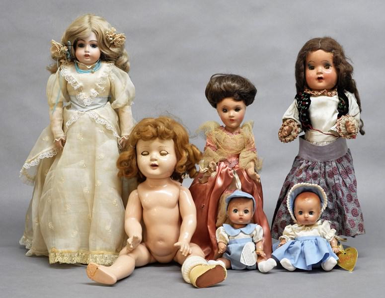 Group of Dolls, Repro Bisque and Five Composition Dolls: Unmarked reproduction bisque doll, pair of contemporary Effanbee twins, compo Nanny, foot as is, face shows cracks, compo unmarked w/new wig & redressed, compo Gypsy (hand as is), clothing shows wear,
