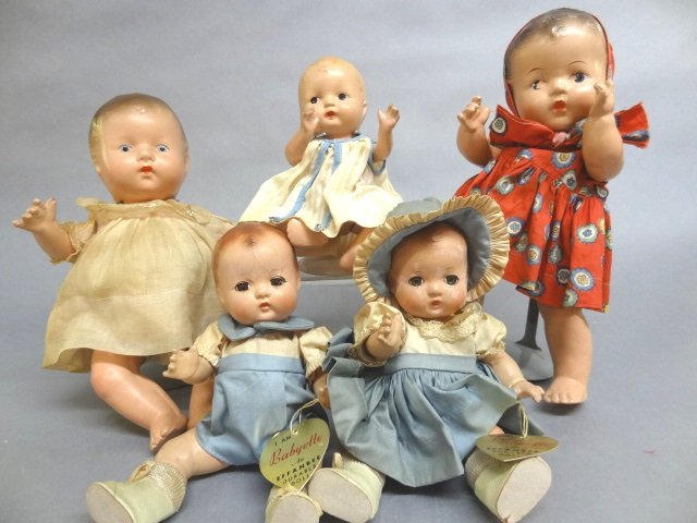 Five Composition Dolls: Effanbee Babyette Brother and Sister 8 1/2" dolls in original clothes and hangtag. Clothes have lot of storage wear. Extensive crazing on both. Three unmarked composition dolls 7 1/2" 10" and 11" in v