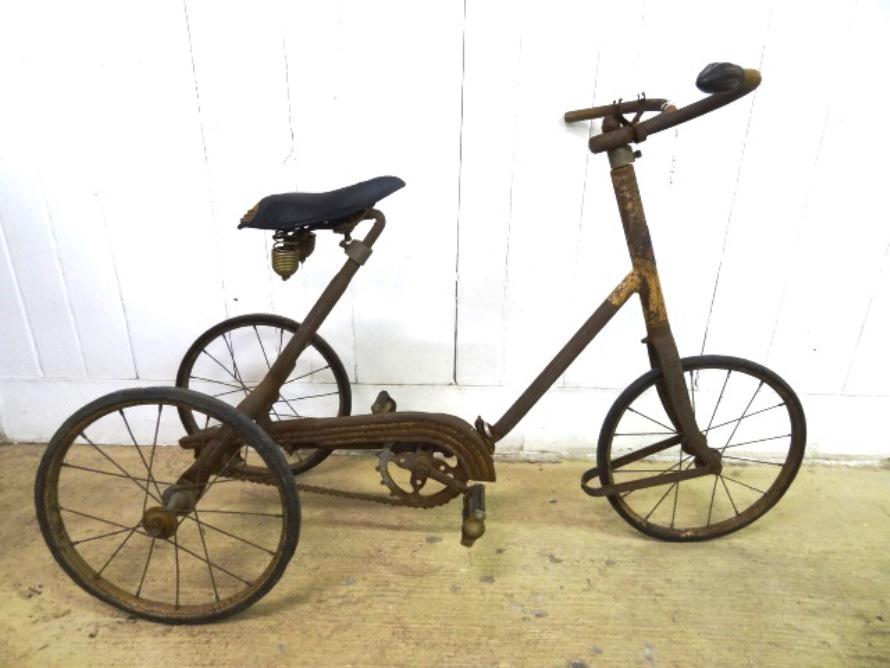 Vintage Tricycle: Vintage Skippy Racer tricycle and designed seat hard roller tires, reflectors and wheel guard, chain driven made by Toledo Ohio US A 28" Tall, 46" Long