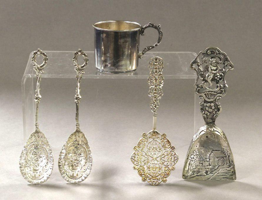 Continental Silver Accessories: Four decorative serving spoons from .800 to .925 silver, 5.25"L, child's .900 cup 2"H, 4.2 ozt total weight