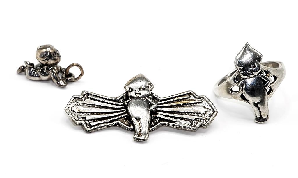 Kewpie sterling Pin, Ring & Charm: Kewpie Art Deco bow pin marked sterling 1.5"W, Ring marked sterling with Kewpie 7/8"H, unmarked sterling charm