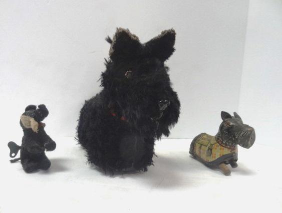 Scotty Dog Toys , Battery Op and Key Wind: Large battery Operated Scotty dog, 10 8" missing bottom for batteries, together with Key Wind decorated Marx Wee Scotty, not tested, and small black key wind Scotty 3 x 4"