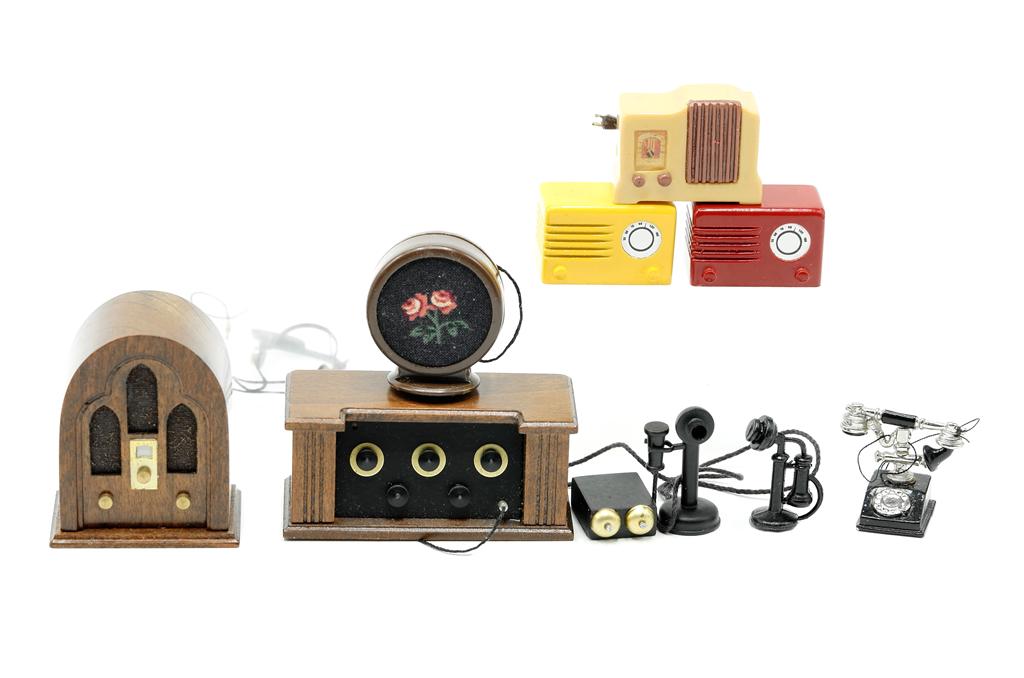Robert Carlisle Dollhouse Radios & Telephones: Robert Carlisle mahogany dome top radio 1.75"H, mahogany radio with speaker on top 2"W, three Bakelite style radios, three cast metal telephones