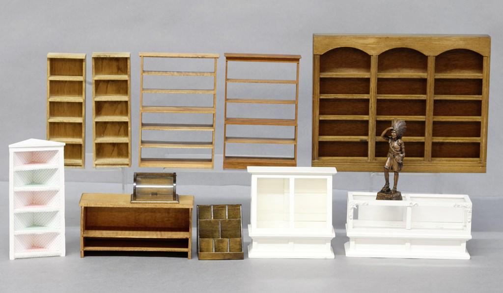 Dollhouse Store Fixtures & Supplies: Two white store display cases 4.75"W and 6.5"W, three section bookcase 7.5" by 9.5", display shelves, counter 6"W, cigar store Indian 4.25"H