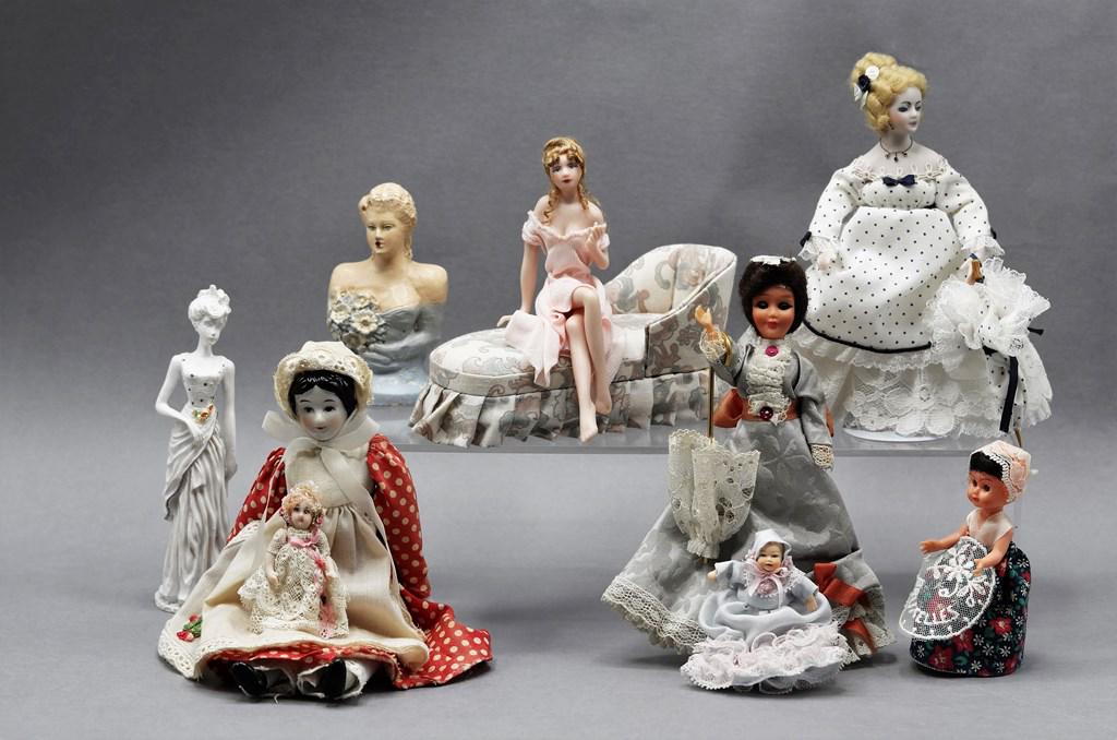 Dollhouse Miniature Dolls: Bisque lady in nightgown with an upholstered daybed 5"L, bisque doll wearing blue and white gown 6"H, bisque child with lace dress 2.25"H, jointed china doll with red and white dress 7.5"H, cast resin
