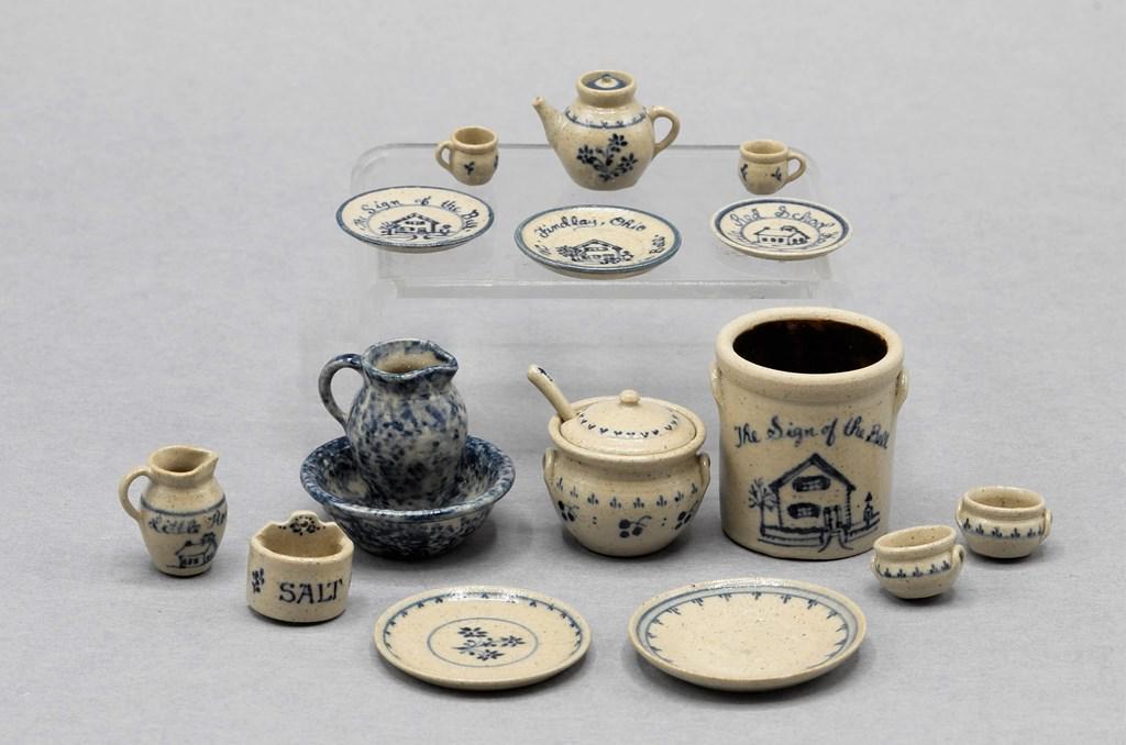 Jane Graber Artisan Dollhouse Earthenware: Assortment of signed Jane Graber salt glazed earthenware decorated with cobalt, large crock 1 1/8"H with three similarly decorated plates, teapot with two matching cups, two chargers, pitcher, salt bo