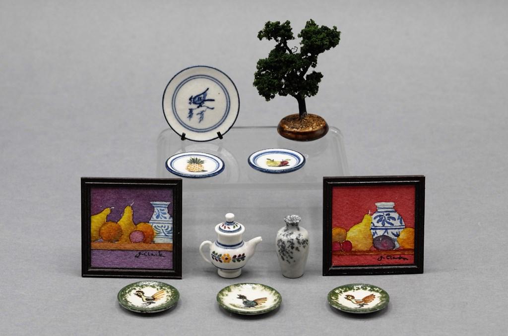 James Clark Artisan Dollhouse China & Paintings: James Clark signed dollhouse china, blue bird decorated charger on stand 1 1/8"D, three rooster plates, two fruit decorated plates and a teapot, Clark signed Bonsai tree, pair of Clark hand painted st
