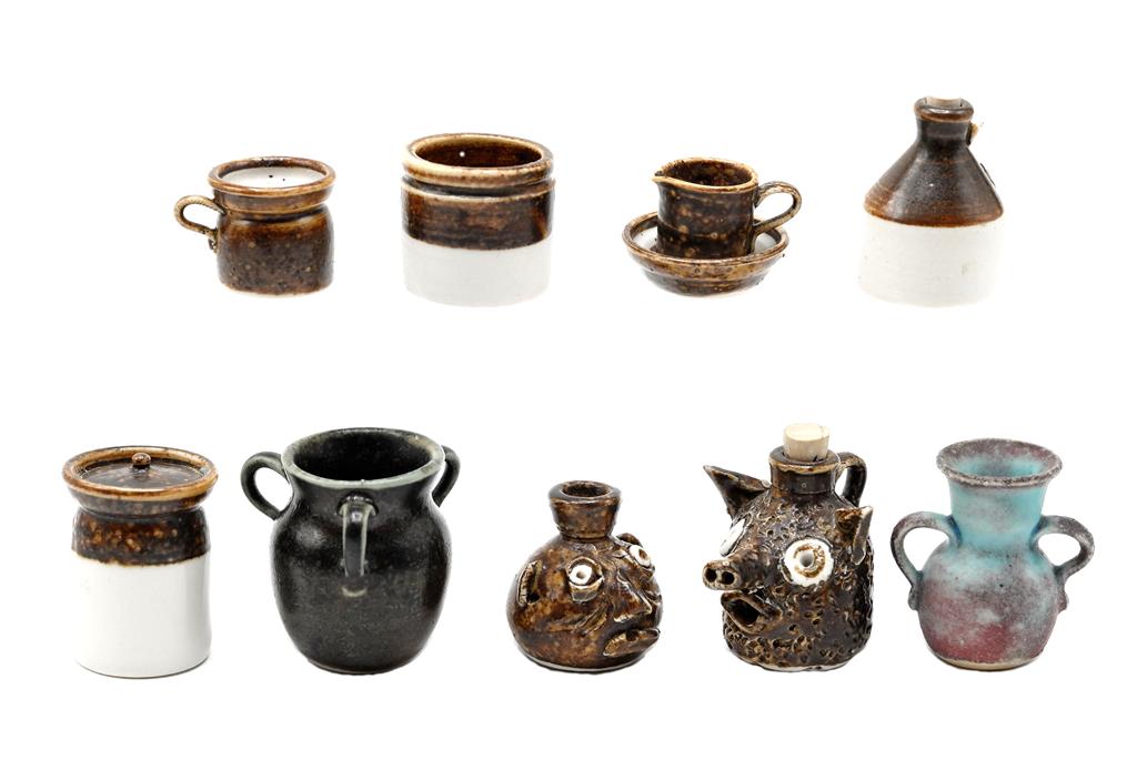 Artisan Southern Dollhouse Pottery: Nice collection of dollhouse china all signed AM, two southern style face jugs 1" and 1 1/8"H, triple handle crock 1.25"H, double handle urn, crocks, pitcher and bowl set