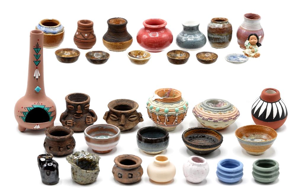 Southwest Style Dollhouse Pottery: American south-west style dollhouse pottery includes fireplace 3 3/8"H, storage jars, jugs, bowls, face jars, etc., several are artisan signed, also includes a small resin Indian doll and two Enesco r