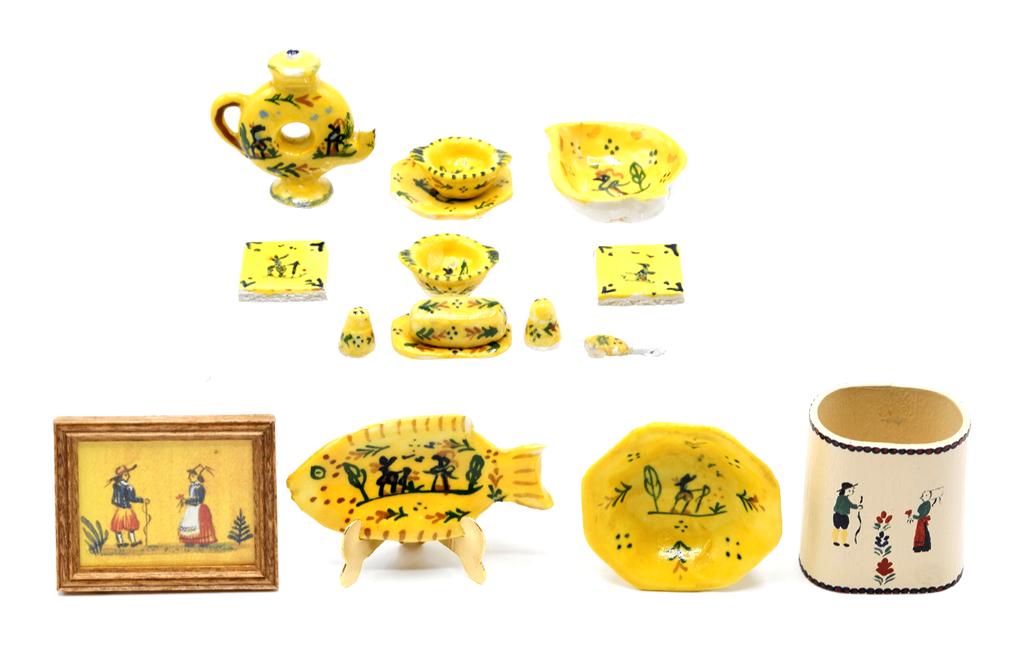 Elisabeth Chambers Dollhouse Faience China: Assortment of faience with a yellow background all with the mark of Elisabeth Chambers, fish plate 1 3/8"L, deep bowl 1"D, leaf shaped bowl, plate, two small bowls, covered butter dish with knife, sal