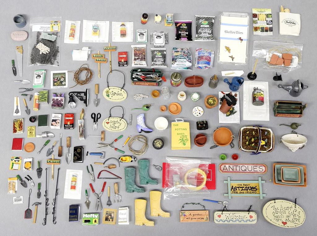Large Group of Dollhouse Garden Accessories: Dollhouse sized garden accessories, watering cans, gas and oil cans, boots, books on flowers, signs, hand tools, hanging baskets, pots, tool boxes, basket of flowers signed MF, hose, bags and boxes, l