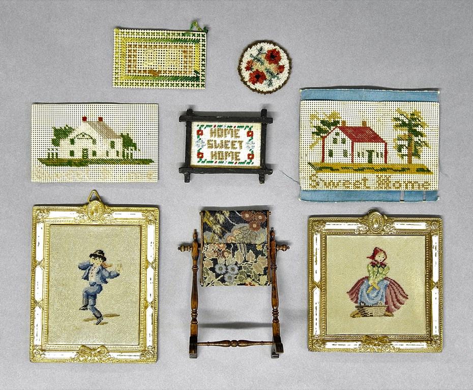 Dollhouse Needlework Accessories: Vintage fabric panel on an unsigned mahogany stand 3.75"H, round hand hooked rug by Jane McCandless 1.5"D, two vintage Dutch children in painted metal frames with paint wear 4.5" square and 3.25" by 4