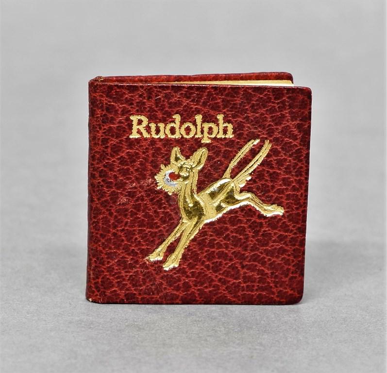 Signed Miniature Rudolph Book: Miniature copy of Rudolph signed by author Robert L. May, and by the publisher, bound in gold tooled leather, printed by The Schori Press circa 1963 2" square, numbered 139 of a reported 200 copies