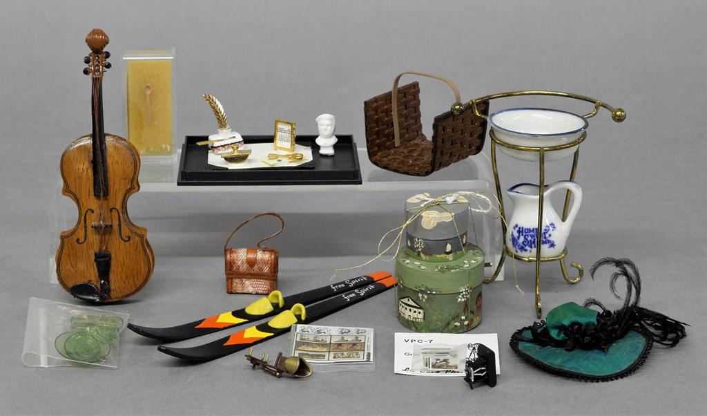 Assorted Dollhouse Accessories: Pair of hand painted wood hat boxes signed JP, pair of Free Spirit skis 5.75"L, wood and cast metal bass 4.75"H with edge chip, David Edwards boxwood spoon .5", hat, leather trimmed purse, desk blotte