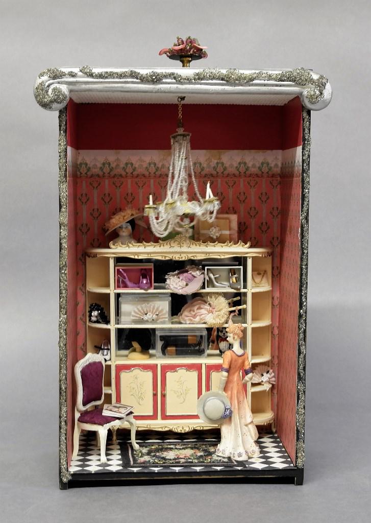 Lady: Small room box made from an old wood drawer, includes display filled with hats and accessories, chair, non electrified chandelier, all bisque figure 5"H, overall measurements 10"W, 16"H, 7"D