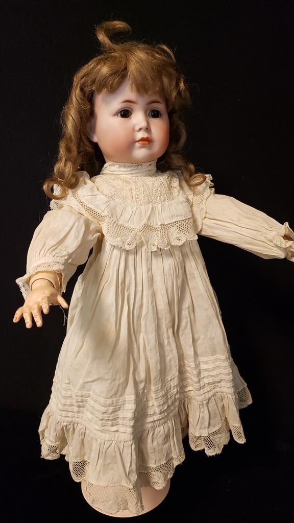 Bisque Doll Simon & Halbig K * R 19": Closed Mouth S & H K * R 19" Doll with repainted body, redressed, new wig, stationary eyes, cannot get pate off, beautiful face. Leather French Style shoes. Seems in good Condition