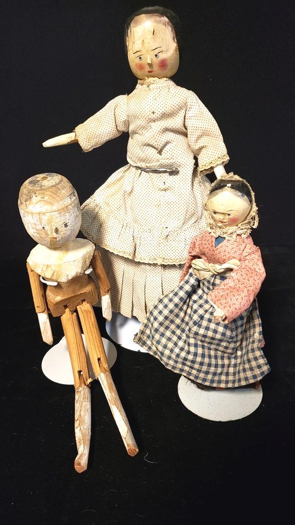 Three Peg Wooden Dolls: Largest 11 1/2" largest, one without clothing, both vintage clothing and wooden arms and legs smaller one missing arm