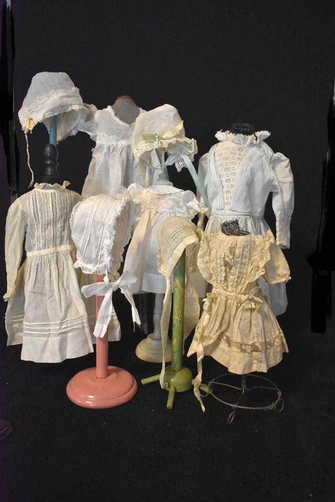 Vintage White Victorian Doll Dresses: Five White Victorian Doll dresses, one slight blue 11" most others are small together with four bonnets.