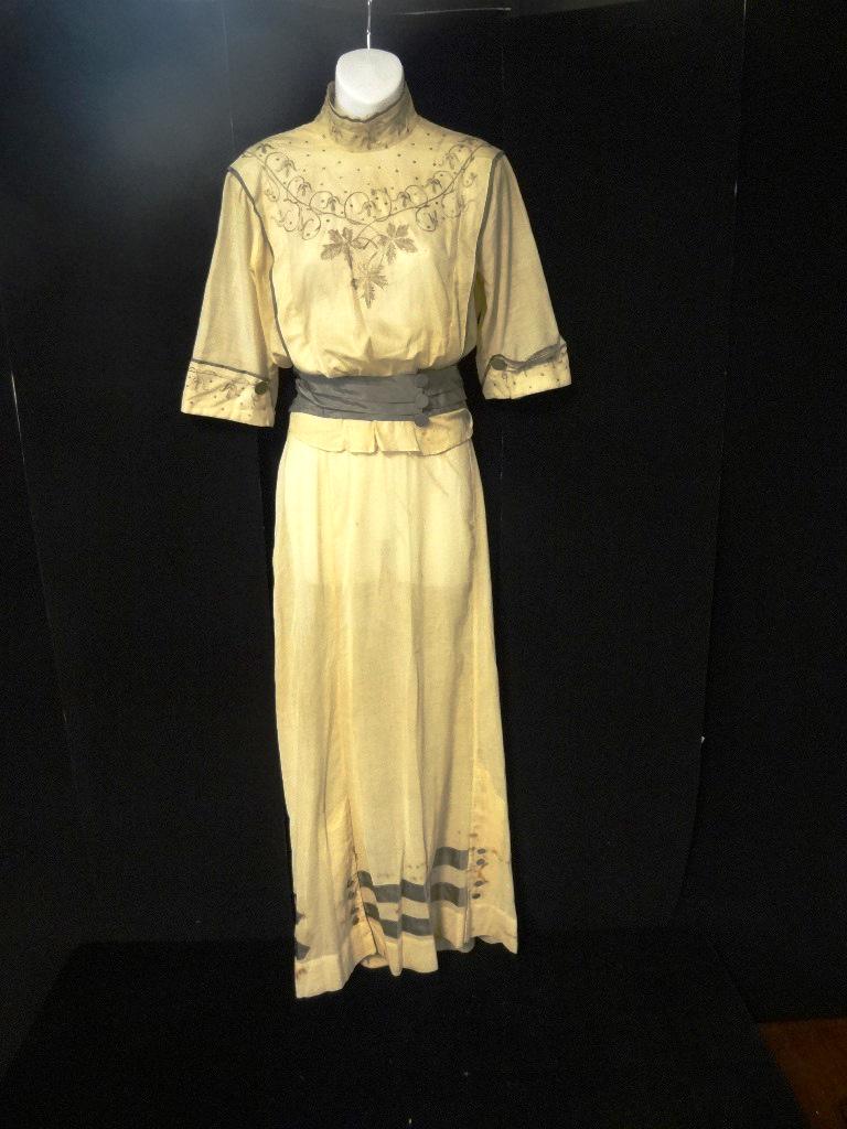 Two-Piece Victorian Tea Blouse/Skirt Ensemble: Beige lightweight linen tea outfit. Blouse has a high neck, 3/4 length sleeves w/cuffs, the high neck, sleeve cuffs and front are embroidered in grey and off white, the edging of neck sleeves and flan