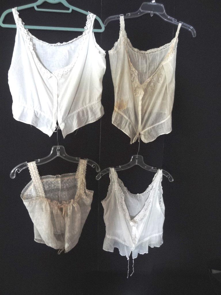 Four Victorian Camisoles: Four Victorian camisoles, all as found, all are cotton, one is relatively plain the other 3 have more lace or embroidery, all need to be refreshed but none have rips, tears, or repairs