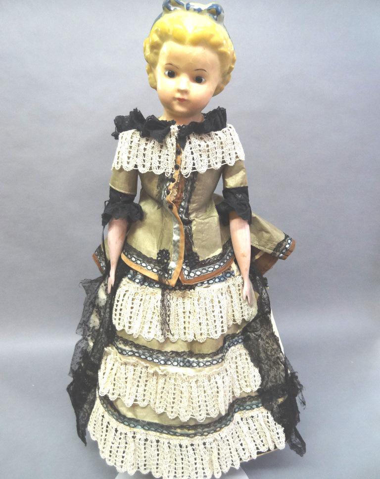 Wax Doll with Wooden arms and legs: Wax Doll 31" with incredible face and hair, closed mouth, hair and ribbon are also wax, Glass eyes, this doll has been redressed. Special feature stuffed body with wooden arms and legs that have paint