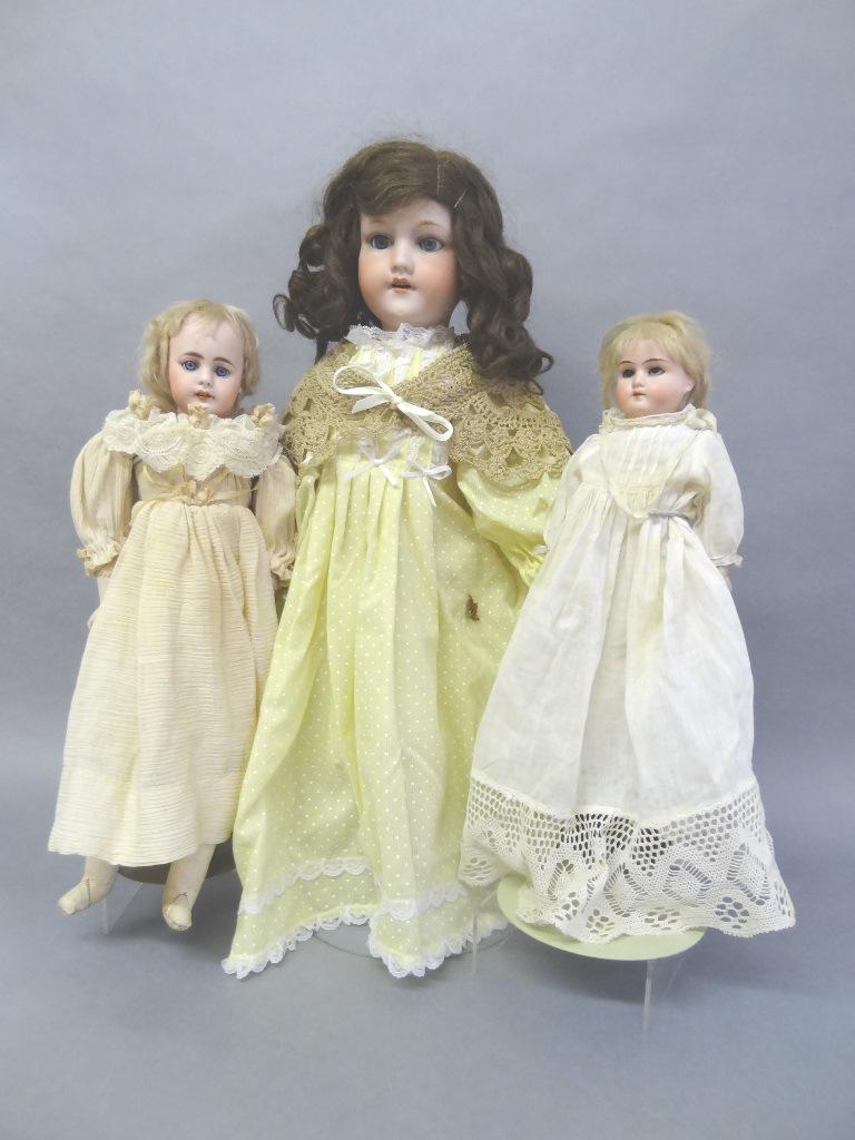 Three Bisque Dolls: A&M #490 24" redressed, new wig glued to head, composition body, open close eyes, seems good, open mouth #51 bisque doll gusseted leather body, open close blue eyes, square teeth, redressed, appear ol