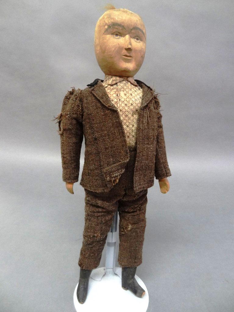 Wooden Folk Art Doll: 13 1/2" wooden folk art doll, may have had hair, arms face, wooden body one missing toe, painted black, no maker, great old suit