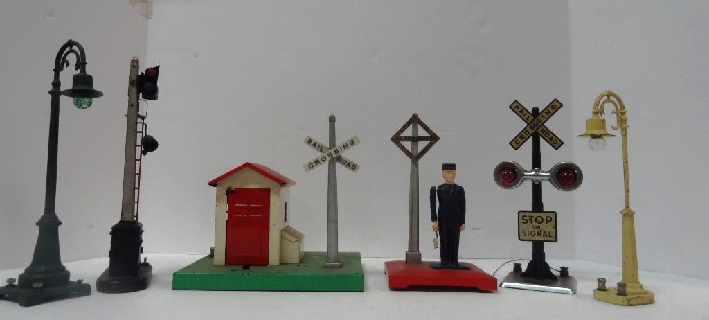 Six operating Train Assorted: 45 Gatemen, 1045 Flagman, Marx Crossing Signal, Lionel 153 Two Lamp Posts, Pre-War 58-19 Lamp