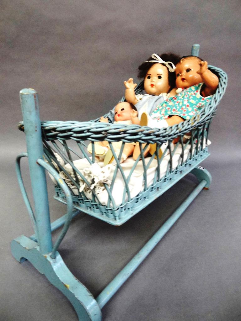 Blue Wicker Basinet Together with Madam Alexander Doll: Blue wicker bassinet 18" (T), 23" (W), good condition, 3 composition Madam Alexander dolls, 2 Dionne Quints, one Annette repainted face, new dress could be original open/close eyes, composition body, 